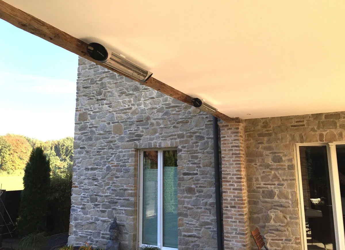 Dos calefactores Veito Blade instalados en la viga de un porche de piedra